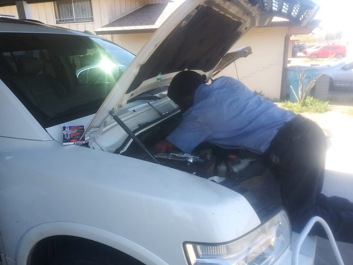 Ryan working under the hood of a vehicle at a customer's home